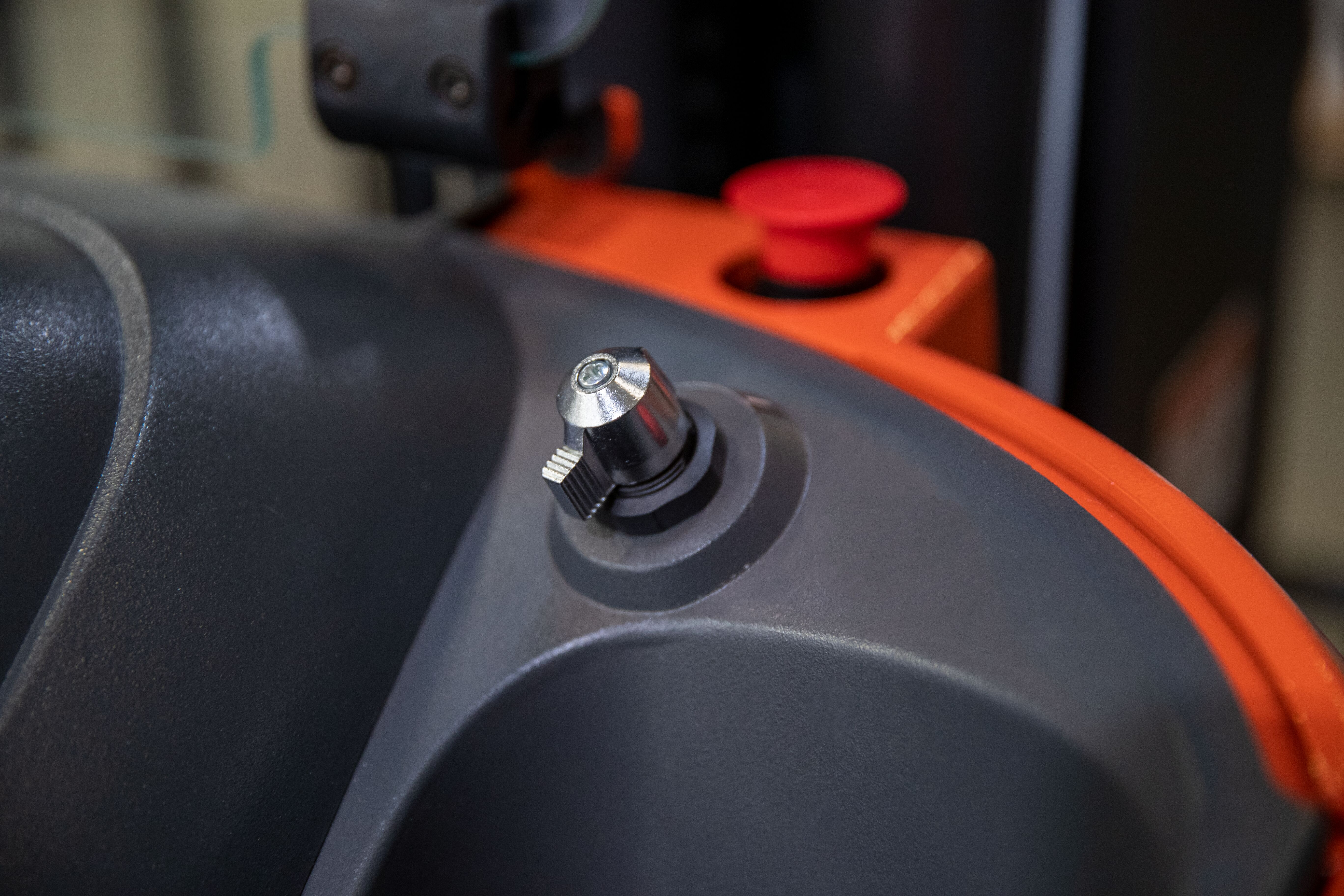 image of button on the dashboard of the inside of the forklift used to start the equipment. no keys are needed